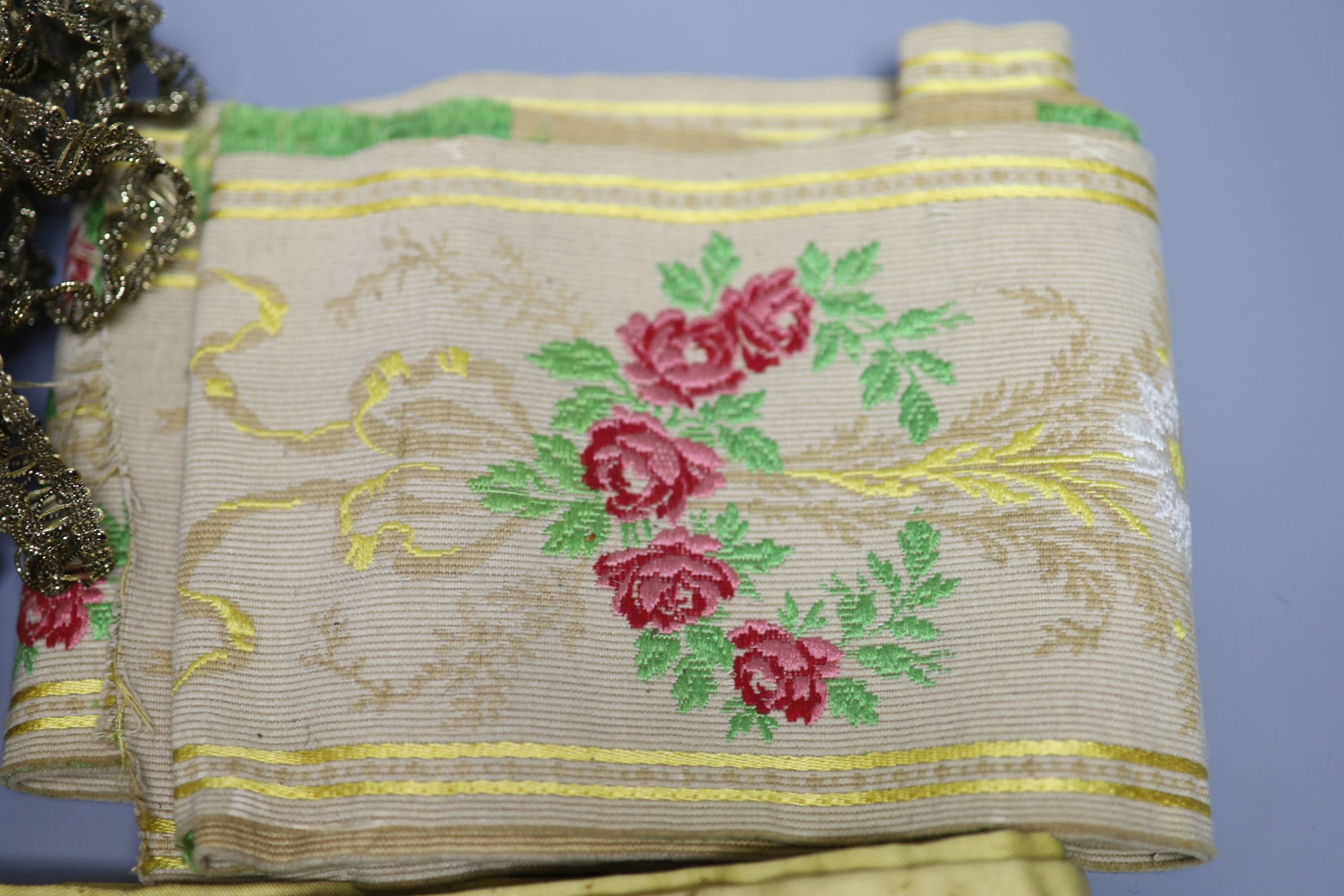 A Lurex 19th century cross stitch pelmet with gold coloured metal bullion fringing, a long French floral braid and a quantity of gold c